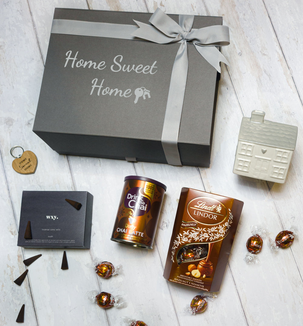 Thoughtful housewarming gift box with incense, chai latte, truffles, and oak keyring