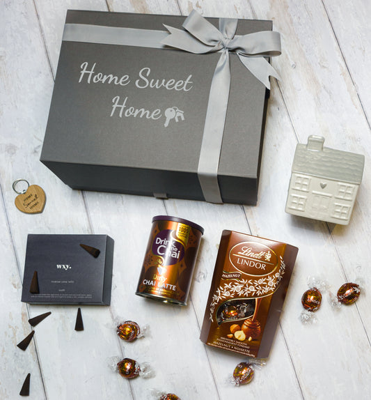 Thoughtful housewarming gift box with incense, chai latte, truffles, and oak keyring