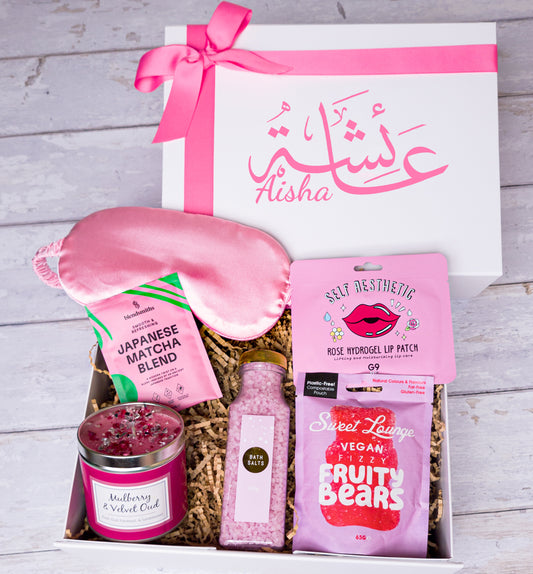 Self-care gift box with matcha, bath salts, satin eye mask, candle, and vegan sweets