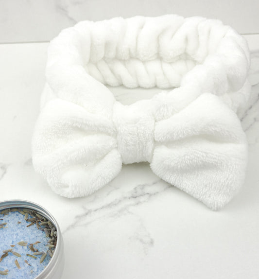 Soft white hair band, 100% polyester, one size fits all.